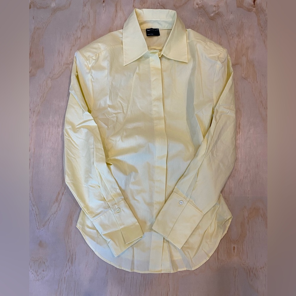 ASOS DESIGN cinch shoulder pad shirt with tie back in buttermilk.
